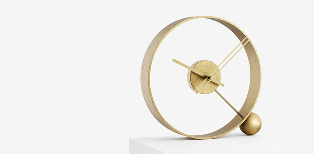 Contemporary Clocks showcasing a modern gold table clock design with minimalistic elements.